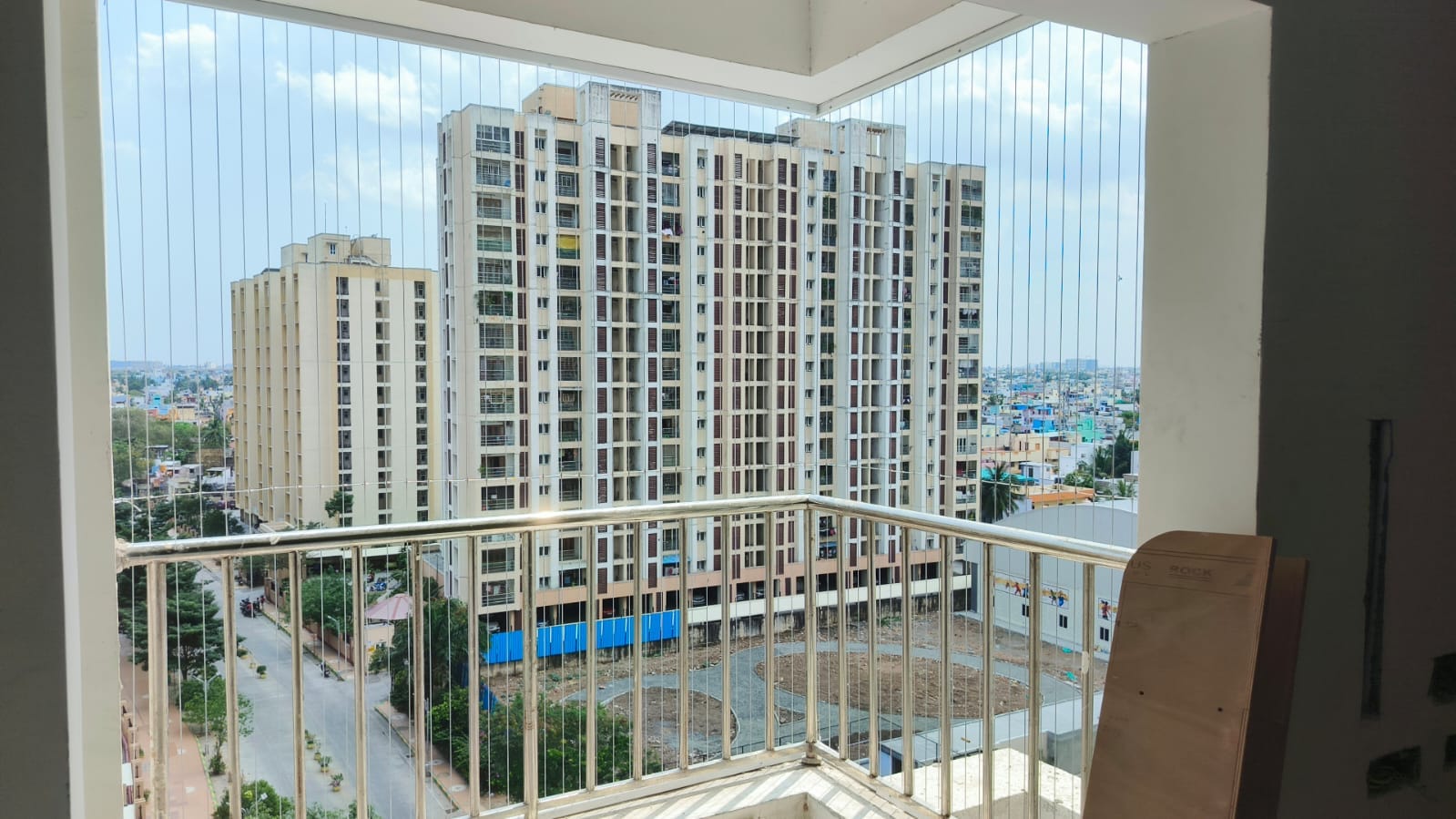 Technician measuring a balcony before invisible grill installation in Chennai
